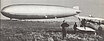 Gerhard Fieseler mit Flugzeug Schwalbe steht vor dem Luftschiff Graff Zeppelin 1930 